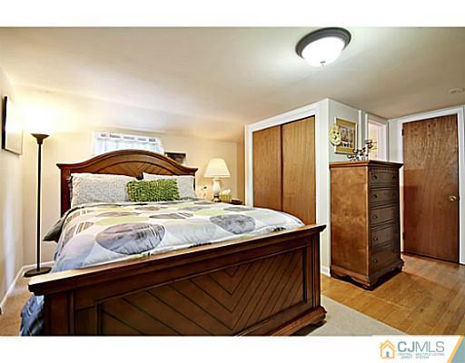 8 June Way Middlesex, NJ 08846 - Photo 17 of 25 a bedroom with a bed and wooden floor
