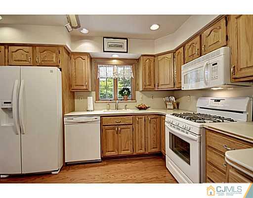 8 June Way Middlesex, NJ 08846 - Photo 9 of 25 a kitchen with a white cabinets and white appliances