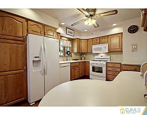 8 June Way Middlesex, NJ 08846 - Photo 10 of 25 a kitchen with cabinets a refrigerator and a stove