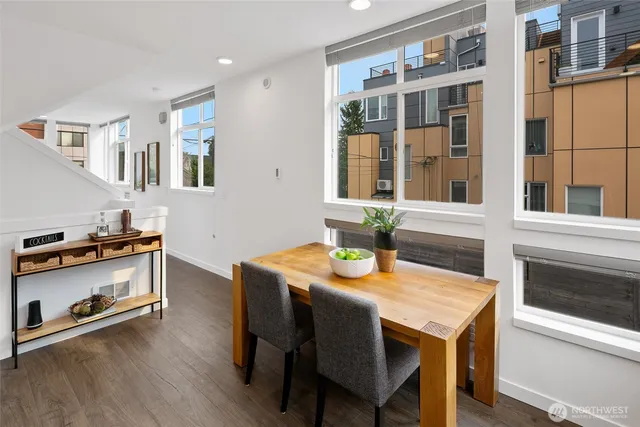 a view of a dining room with furniture window and wooden floor