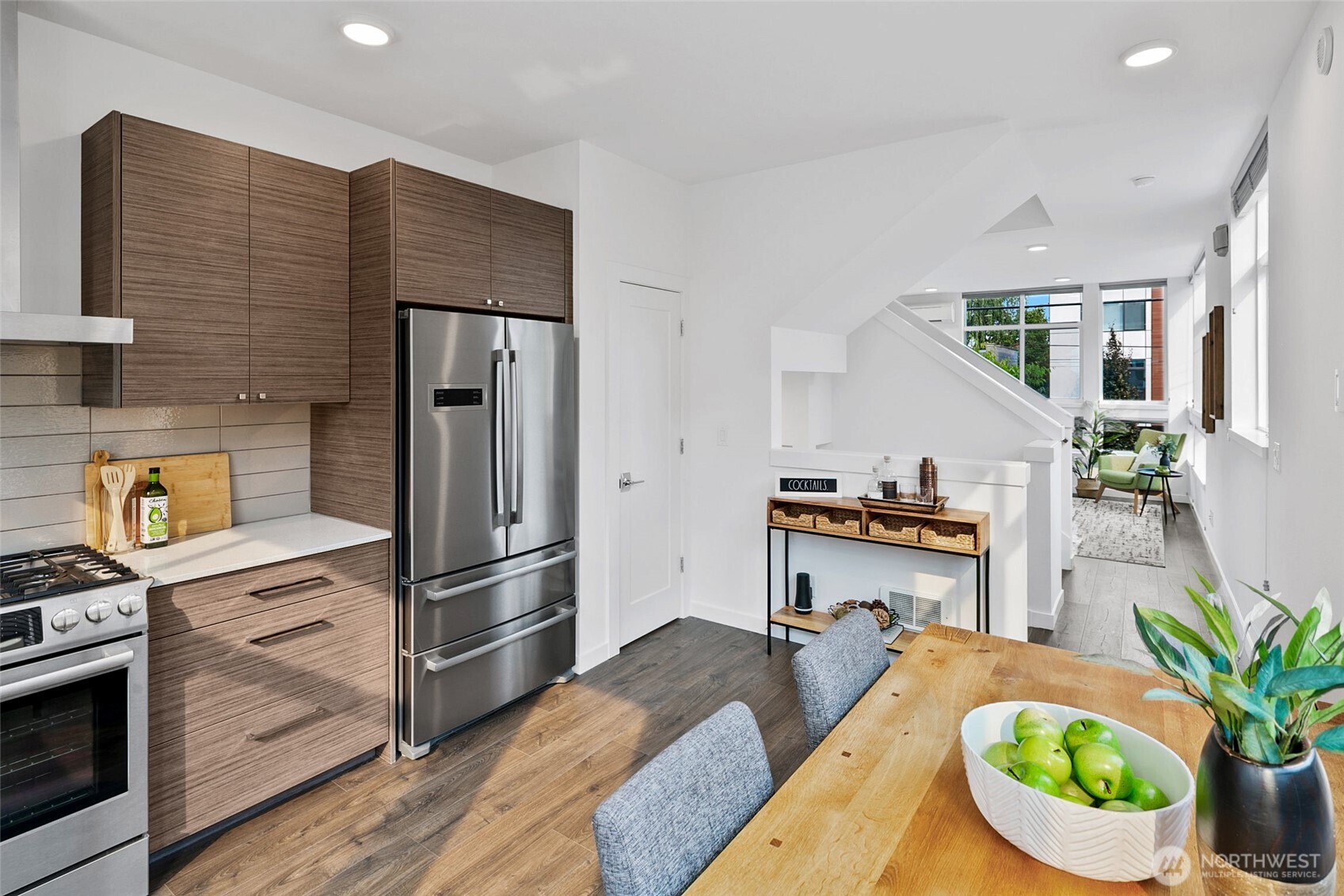 3531 Wallingford Avenue North Seattle, WA 98103 - Photo 12 of 33 a kitchen with stainless steel appliances granite countertop a refrigerator a stove a sink dishwasher and cabinets with wooden floor