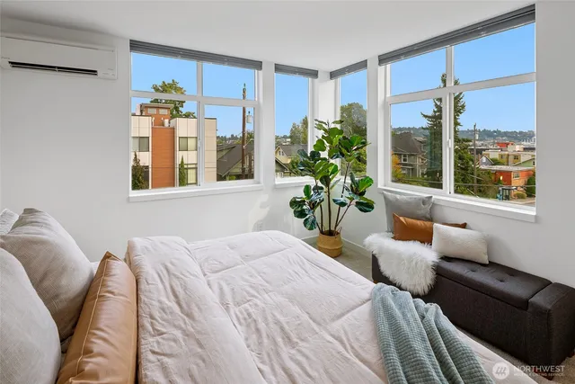 a bedroom with furniture and a potted plant