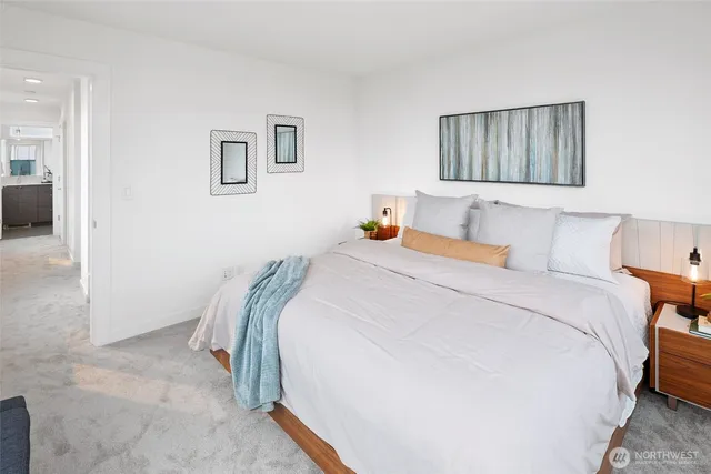 a bedroom with a bed and a painting