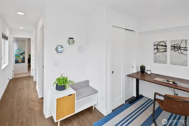 a living room with furniture and a wooden floor