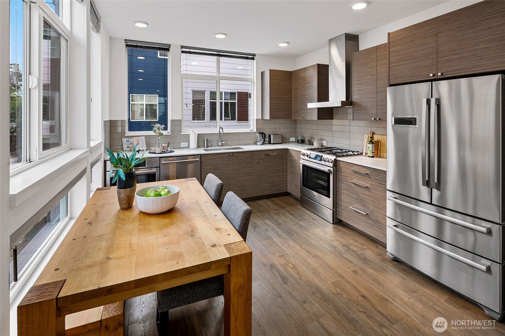 3531 Wallingford Avenue North Seattle, WA 98103 - Photo 7 of 33 a kitchen with stainless steel appliances granite countertop a sink a stove a refrigerator a microwave and island