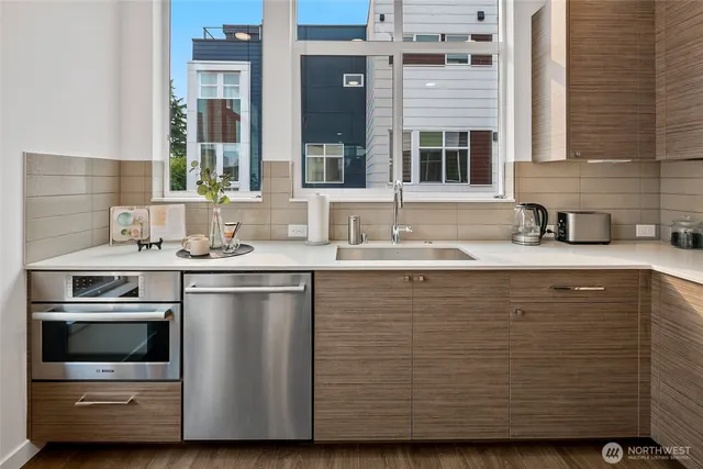a kitchen with stainless steel appliances granite countertop a sink and a microwave