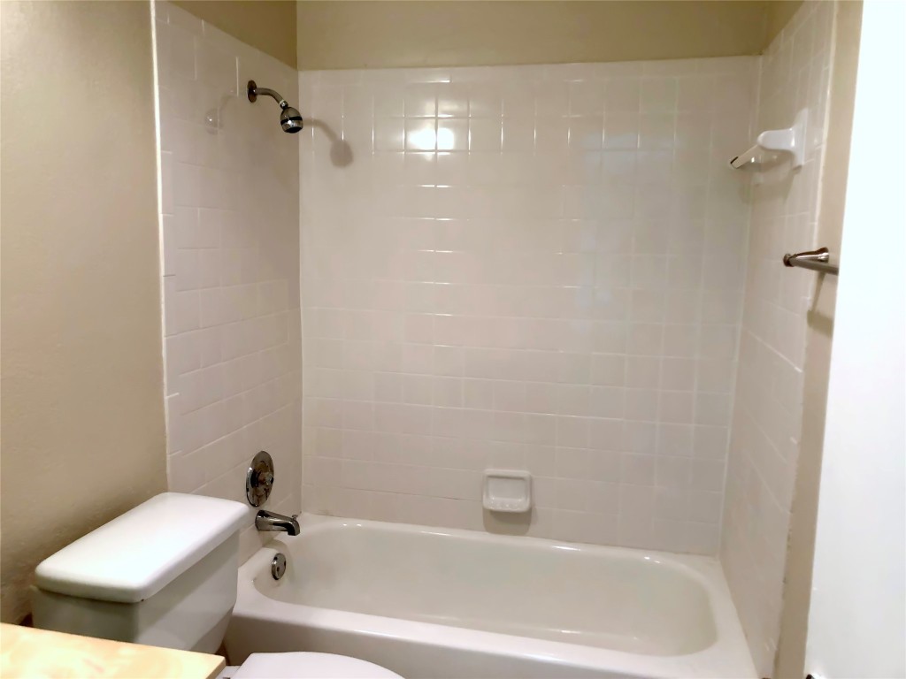 1915 Magazine Street Austin, TX 78727 - Photo 13 of 18 a bath tub sitting next to a white toilet