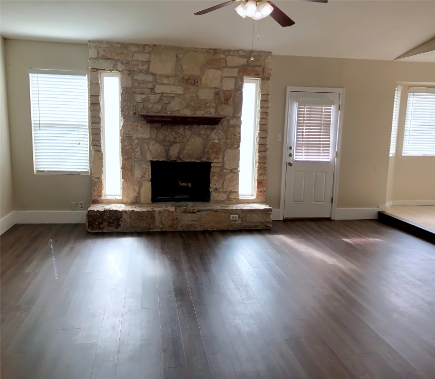 1915 Magazine Street Austin, TX 78727 - Photo 2 of 18 a living room with hard wood floors and a fireplace