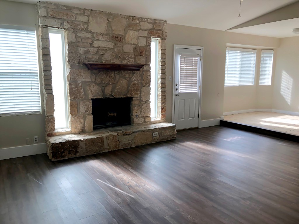 1915 Magazine Street Austin, TX 78727 - Photo 3 of 18 a living room with hard wood floors and a fireplace