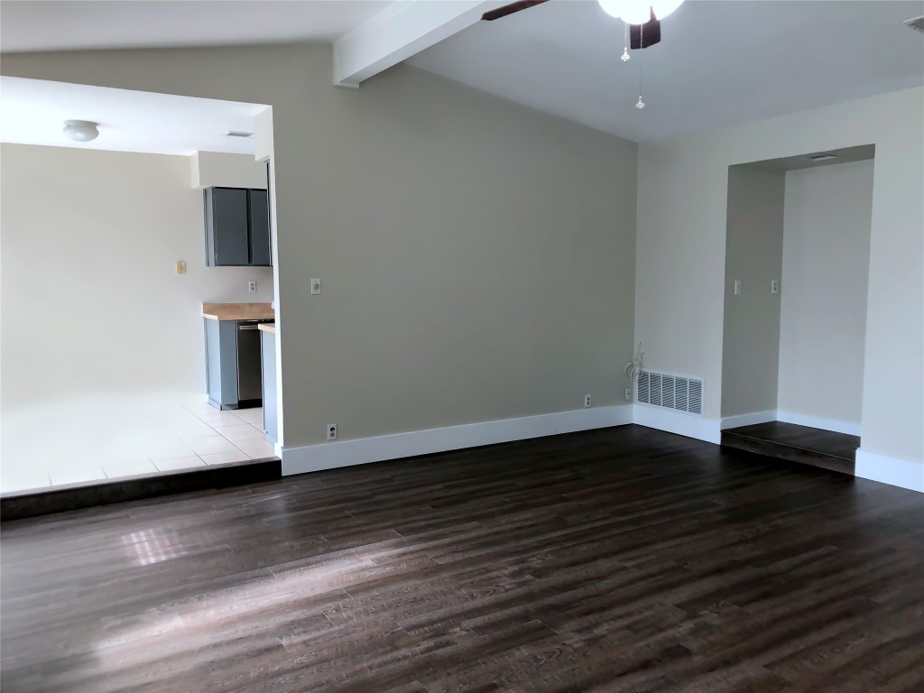 1915 Magazine Street Austin, TX 78727 - Photo 4 of 18 a view of an empty room with wooden floor and a window