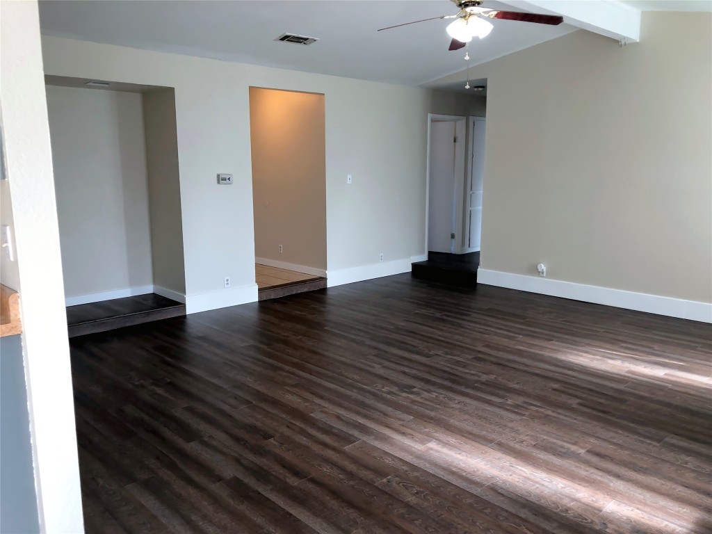1915 Magazine Street Austin, TX 78727 - Photo 6 of 18 a view of an empty room with wooden floor and a window