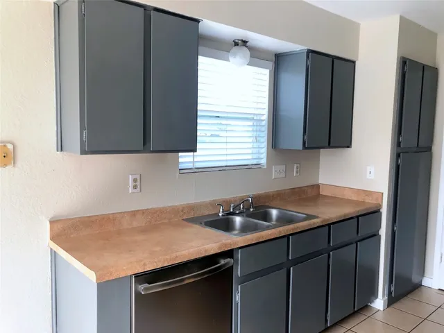 a kitchen with a sink stove and refrigerator