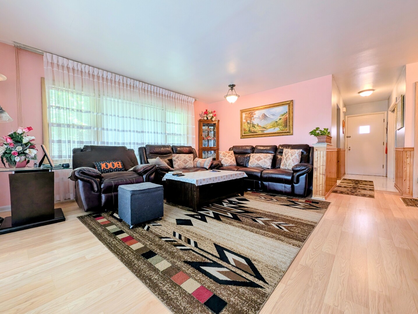 4229 North Keystone Avenue, Unit 3H Chicago, IL 60641 - Photo 6 of 22 a living room with furniture a rug and a floor to ceiling window