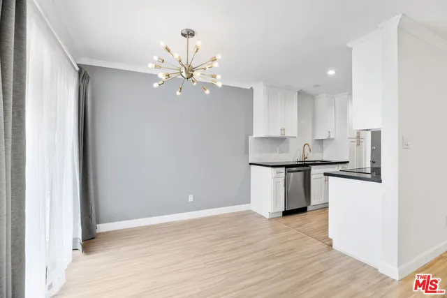 a kitchen with kitchen island stainless steel appliances a sink and cabinets