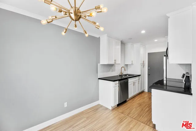 a kitchen with stainless steel appliances a stove a sink and a refrigerator