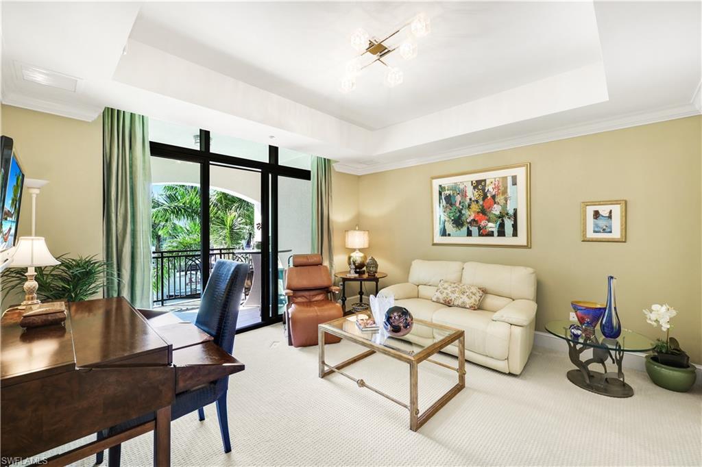 9115 Strada Place, Unit 5314 Naples, FL 34108 - Photo 19 of 49 a living room with furniture and floor to ceiling windows
