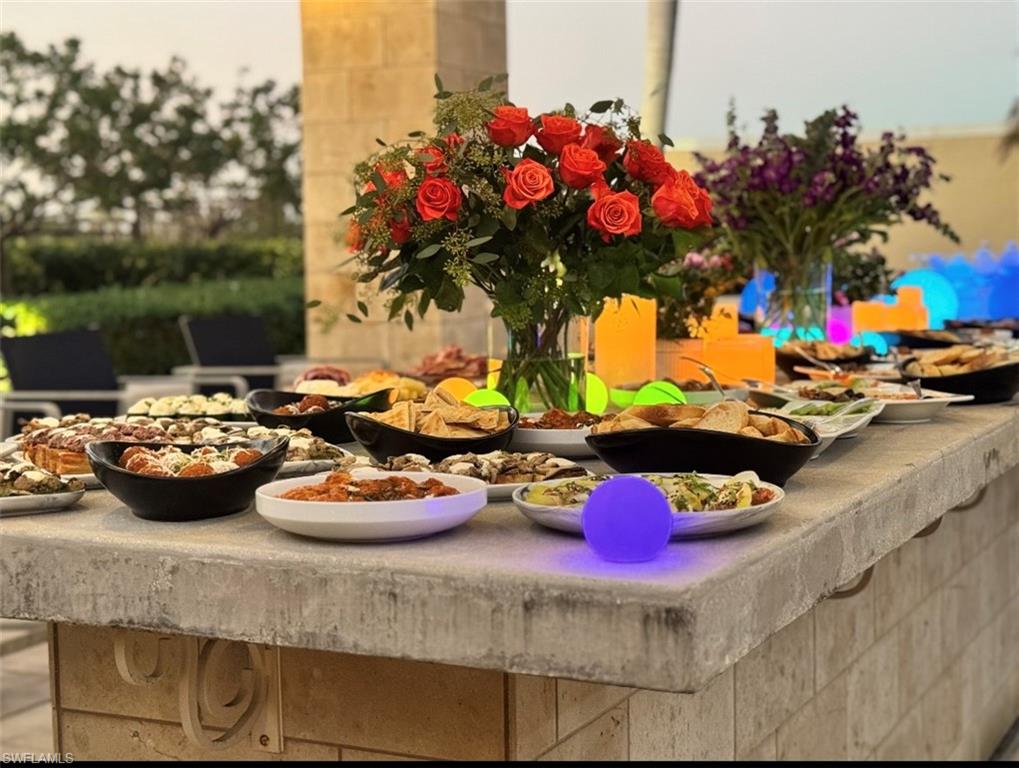 9115 Strada Place, Unit 5314 Naples, FL 34108 - Photo 26 of 49 a store room with lots of flower plants and wooden floor
