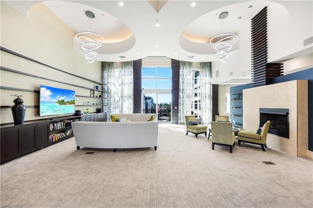 9115 Strada Place, Unit 5314 Naples, FL 34108 - Photo 32 of 49 a living room with furniture and a flat screen tv