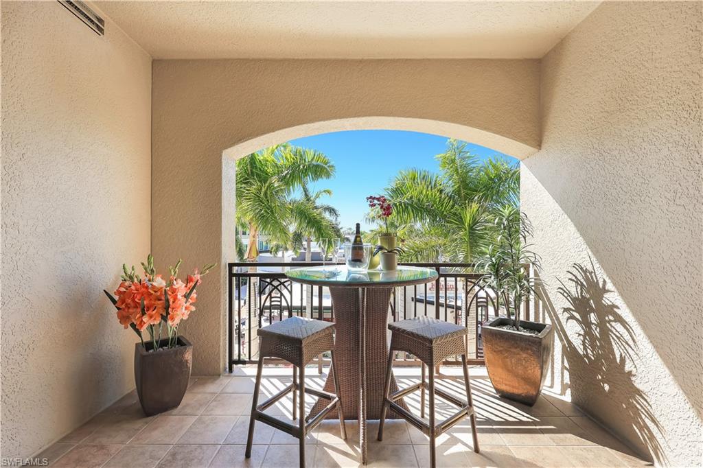 9115 Strada Place, Unit 5314 Naples, FL 34108 - Photo 4 of 49 a view of a chairs and table in the balcony