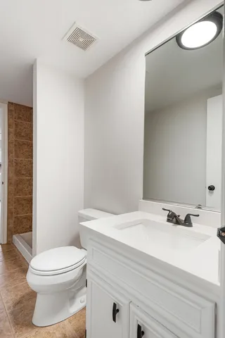 a bathroom with a shower and a toilet