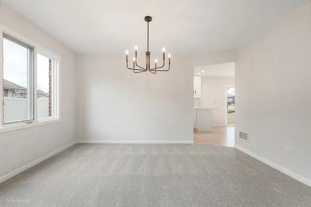 a view of kitchen with stainless steel appliances a refrigerator and wooden floor