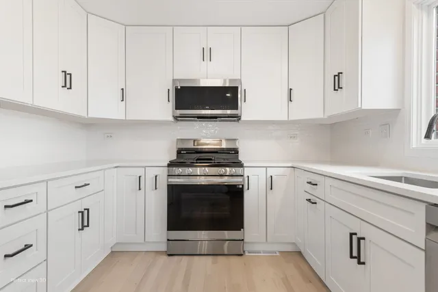 an empty room with fireplace and windows