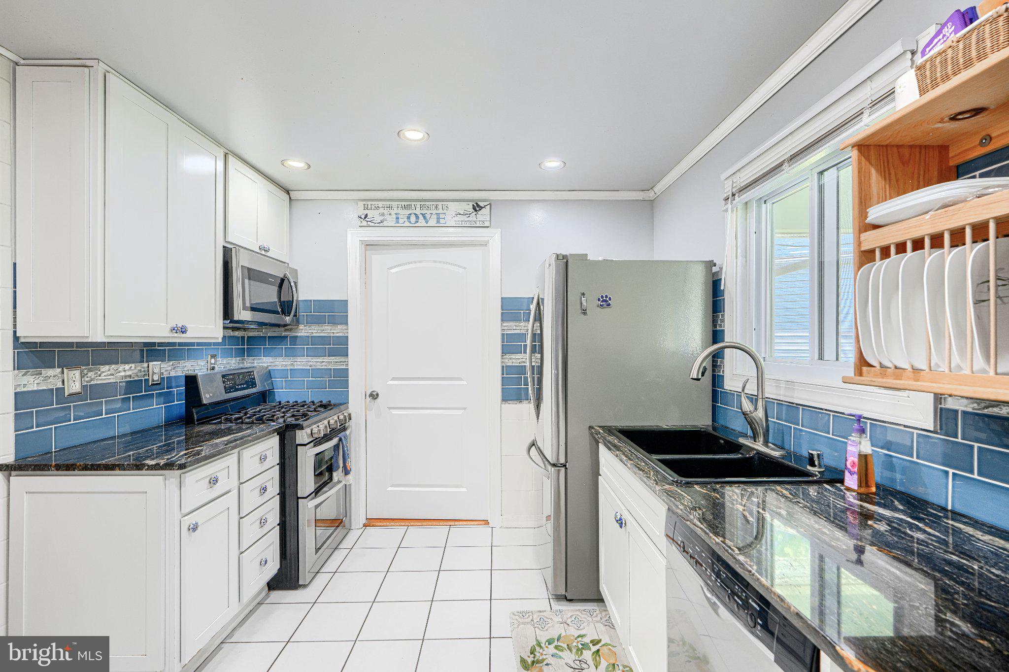 1234 St Andrews Way Baltimore, MD 21239 - Photo 24 of 38 a kitchen with stainless steel appliances granite countertop a stove a sink and a refrigerator