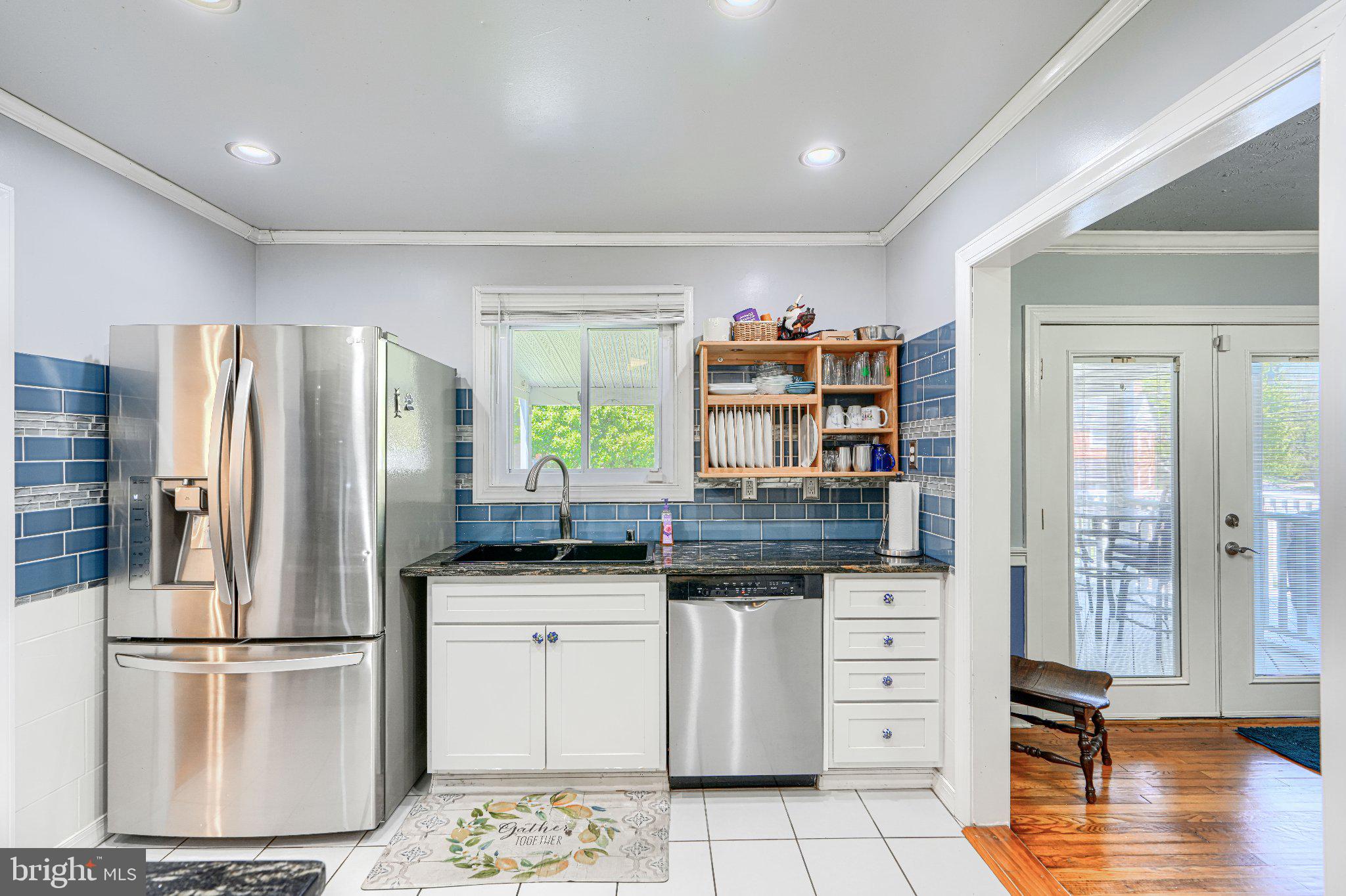 1234 St Andrews Way Baltimore, MD 21239 - Photo 26 of 38 a kitchen with stainless steel appliances a refrigerator sink and cabinets