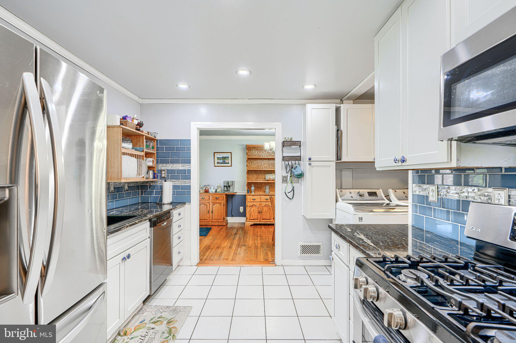 1234 St Andrews Way Baltimore, MD 21239 - Photo 27 of 38 a kitchen with stainless steel appliances granite countertop a refrigerator and a stove top oven