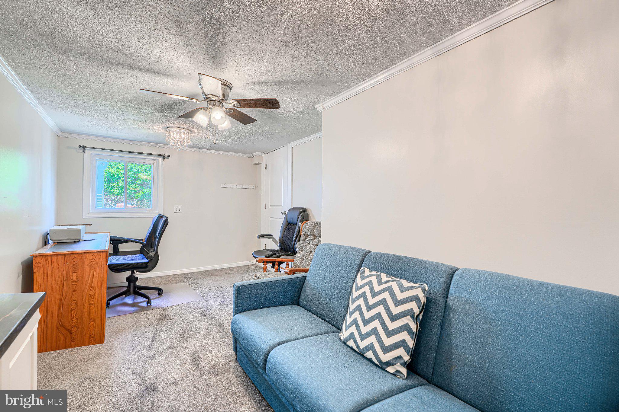 1234 St Andrews Way Baltimore, MD 21239 - Photo 29 of 38 a living room with furniture and a chandelier
