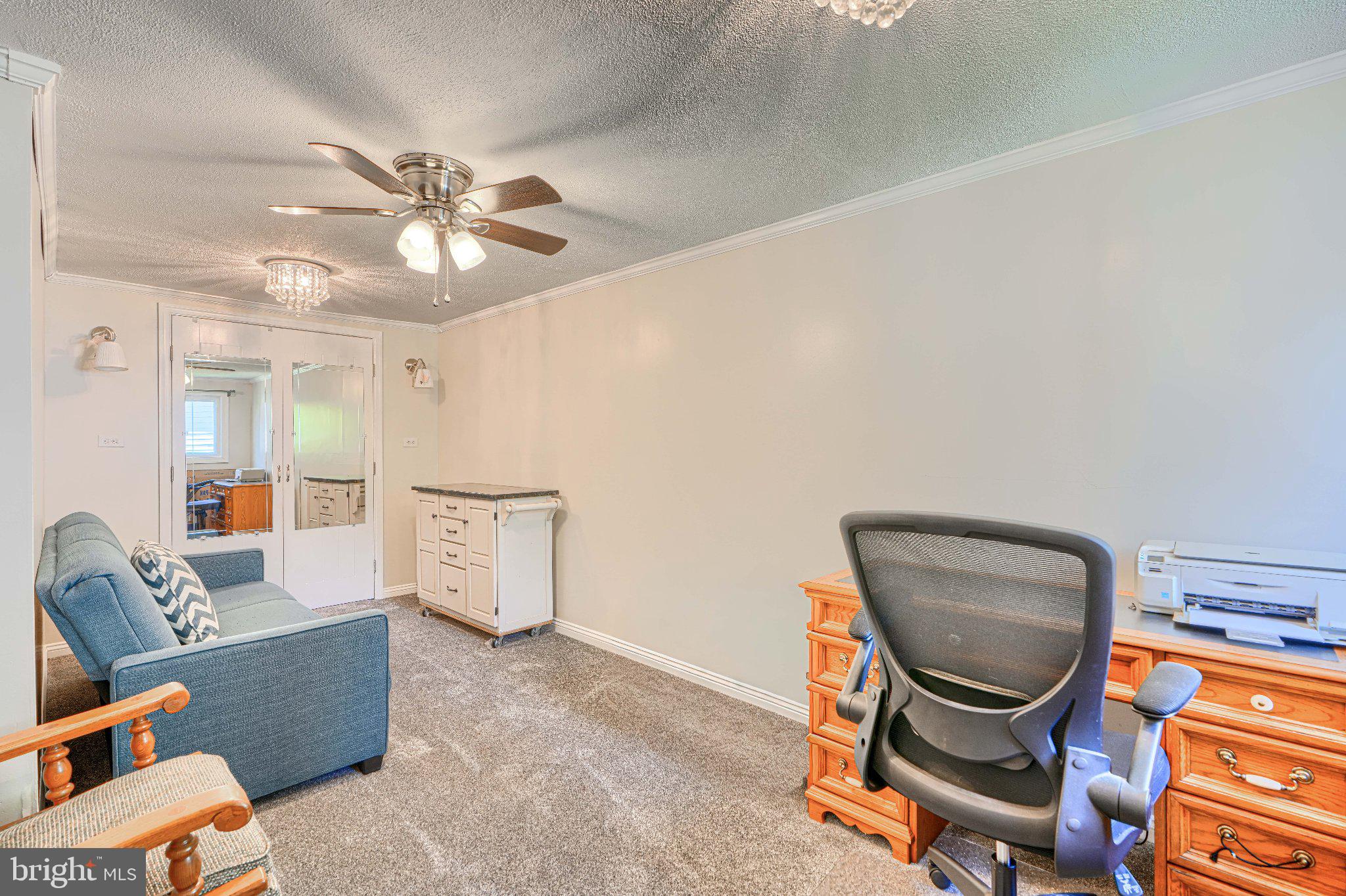 1234 St Andrews Way Baltimore, MD 21239 - Photo 30 of 38 a view of a workspace with furniture and a chandelier fan
