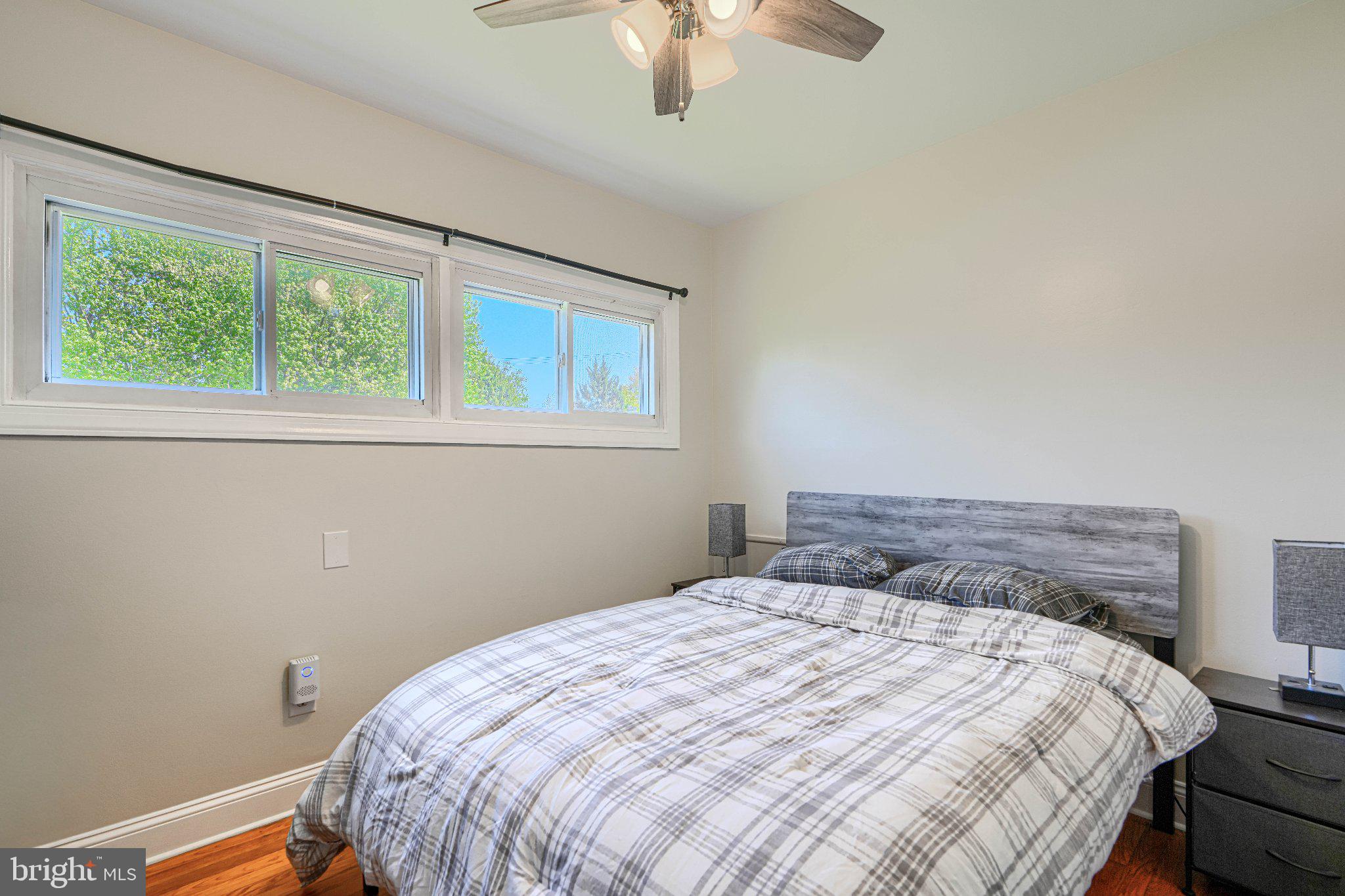 1234 St Andrews Way Baltimore, MD 21239 - Photo 33 of 38 a bedroom with a bed and a chandelier