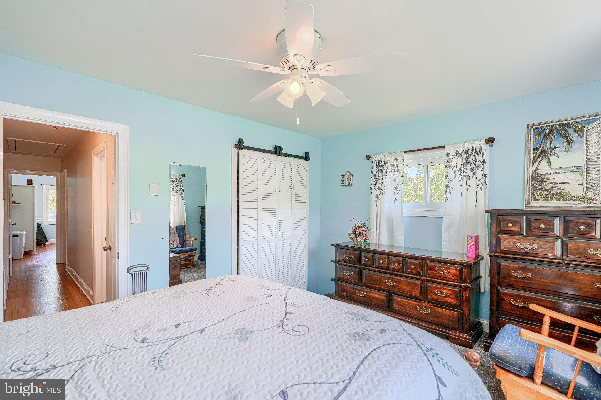 1234 St Andrews Way Baltimore, MD 21239 - Photo 36 of 38 a bedroom with a bed and a chandelier