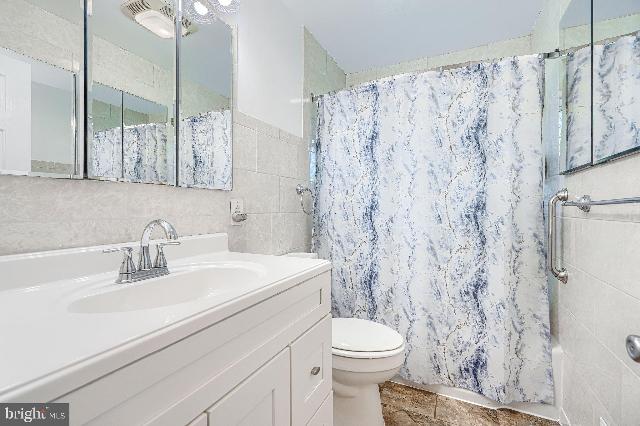 1234 St Andrews Way Baltimore, MD 21239 - Photo 38 of 38 a bathroom with a sink a toilet and shower