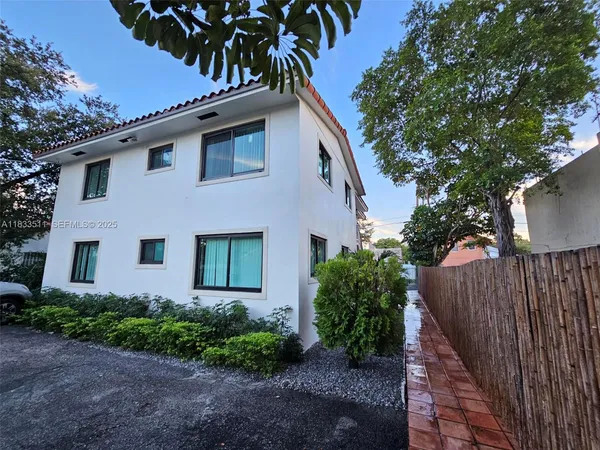 a front view of a house with a garden