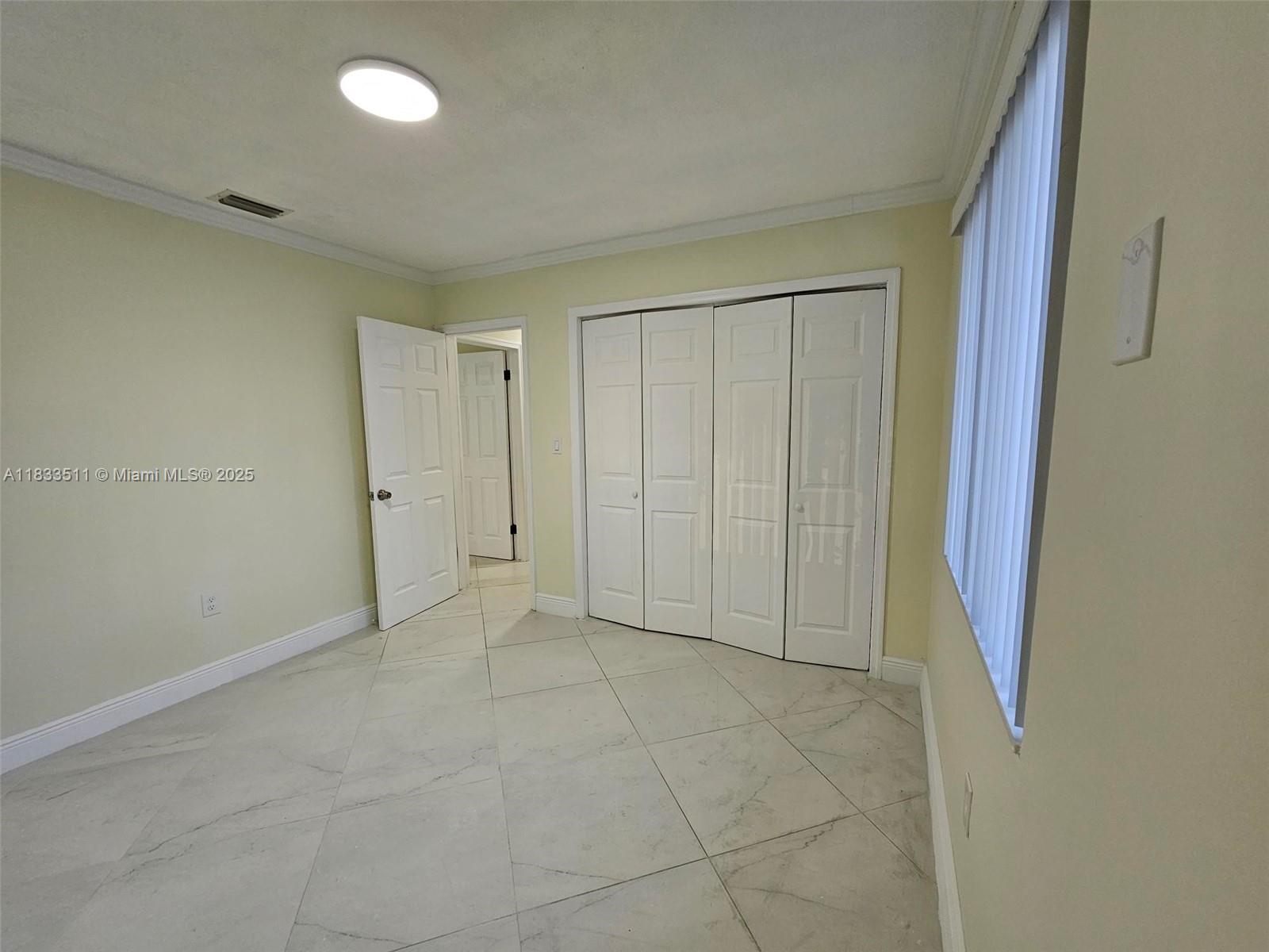 46 Northwest 35th Street, Unit 2 Miami, FL 33127 - Photo 11 of 21 an empty room with a natural light