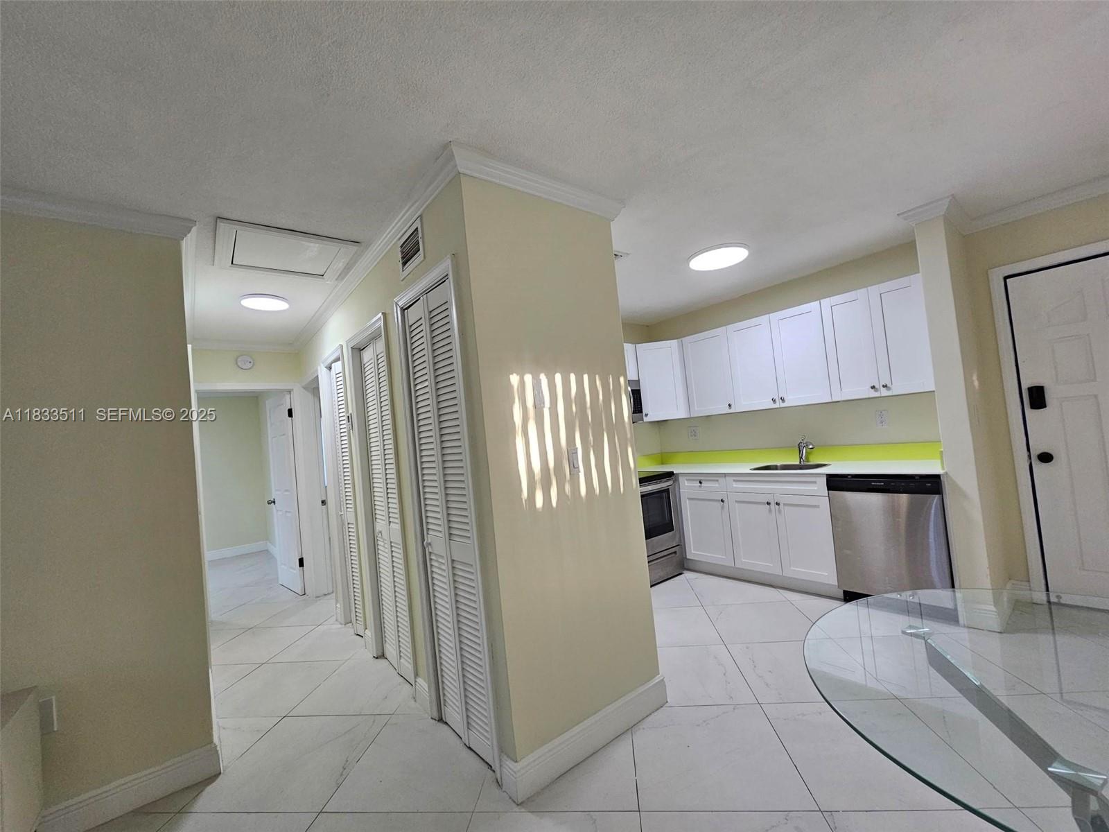 46 Northwest 35th Street, Unit 2 Miami, FL 33127 - Photo 12 of 21 a kitchen with stainless steel appliances a refrigerator and a stove