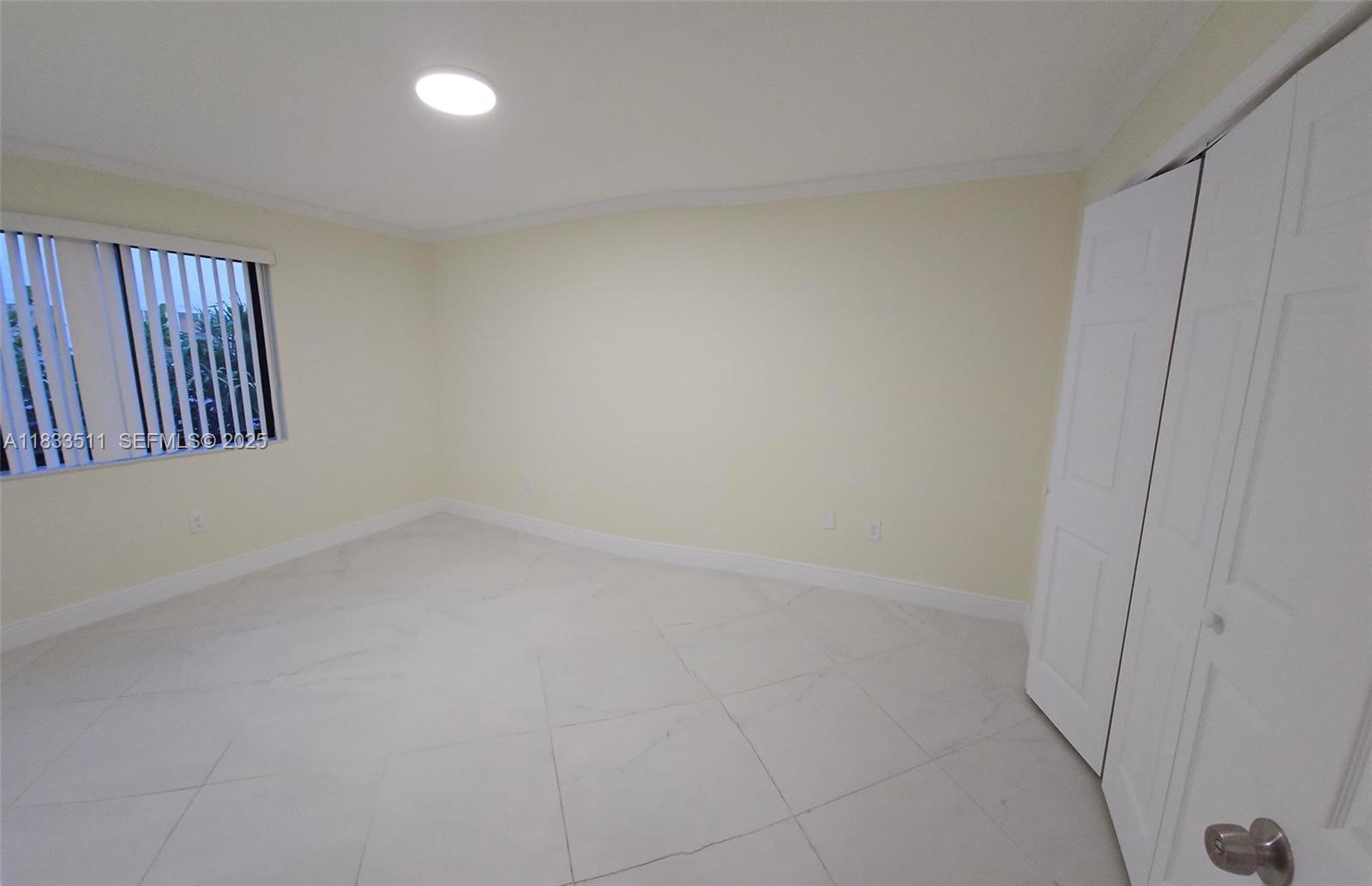 46 Northwest 35th Street, Unit 2 Miami, FL 33127 - Photo 4 of 21 wooden floor in an empty room with a window