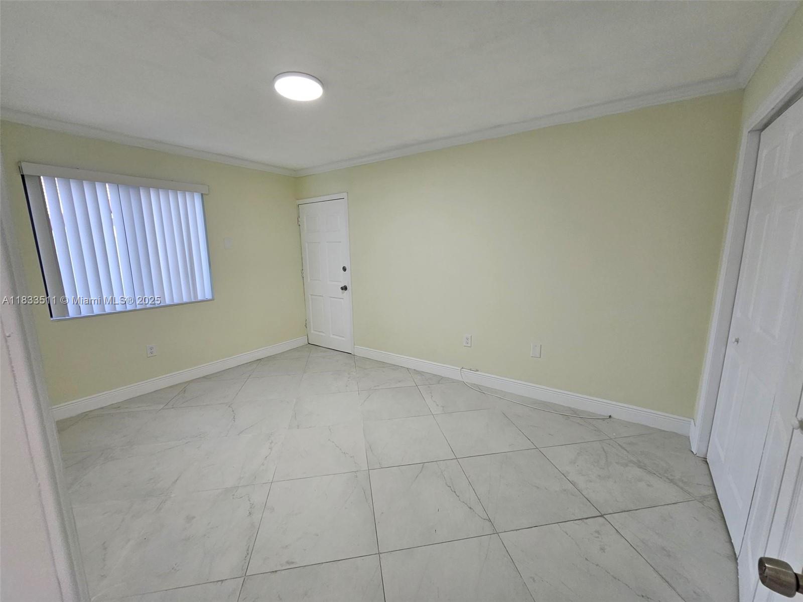 46 Northwest 35th Street, Unit 2 Miami, FL 33127 - Photo 7 of 21 a view of an empty room with a window
