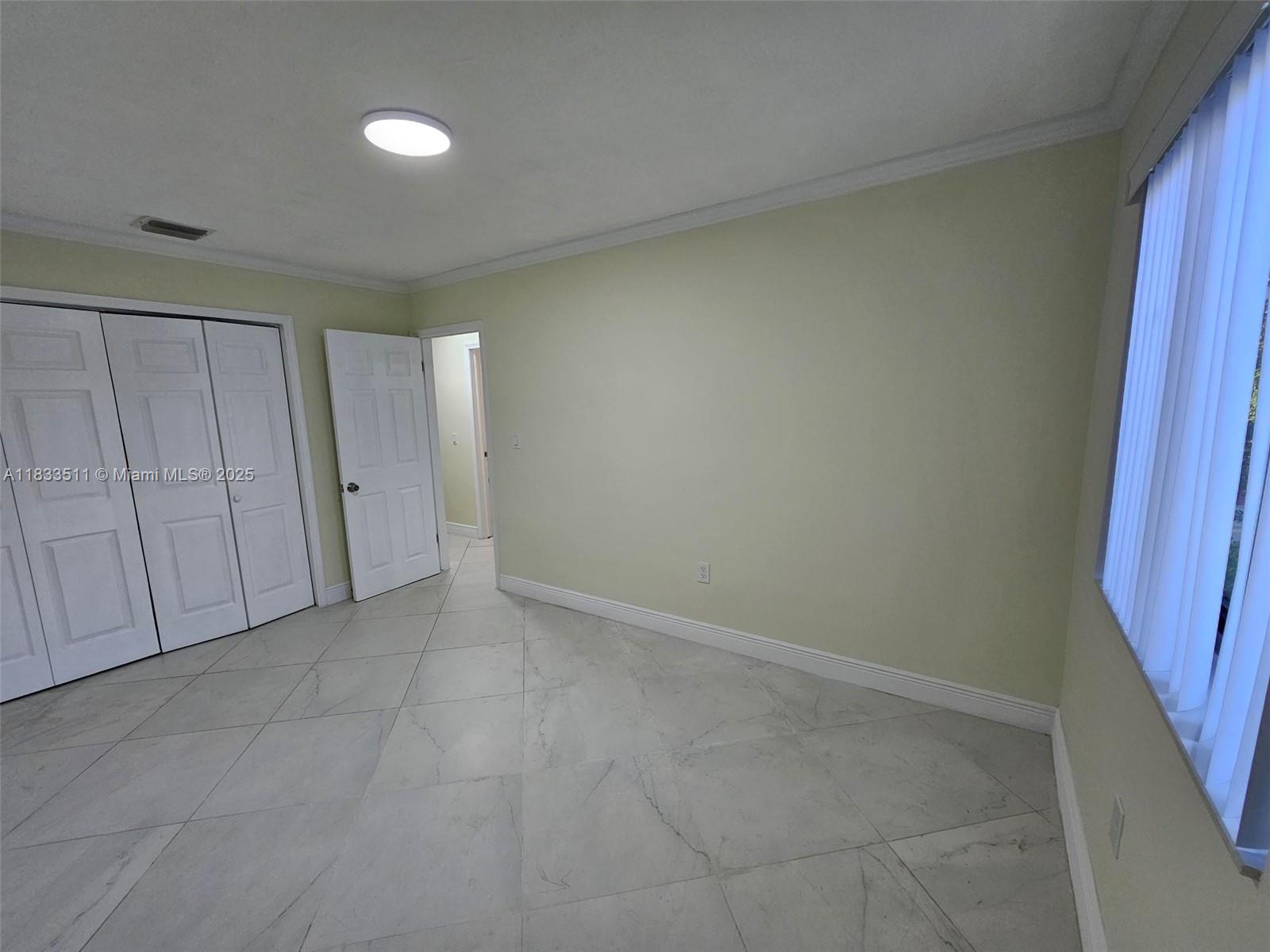 46 Northwest 35th Street, Unit 2 Miami, FL 33127 - Photo 8 of 21 a view of an empty room and a window