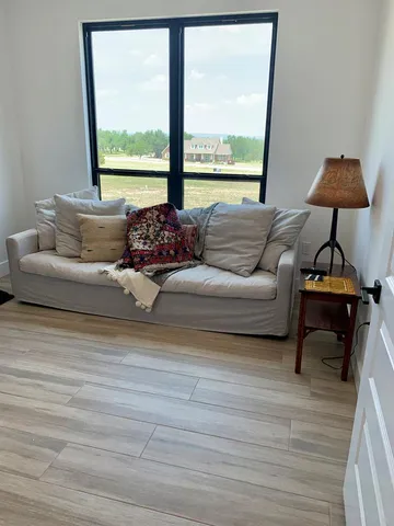 a living room with furniture and a large window