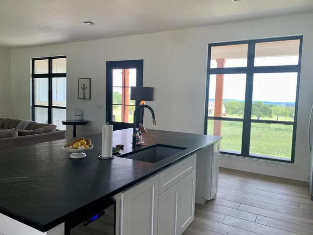 a kitchen with a sink and large window