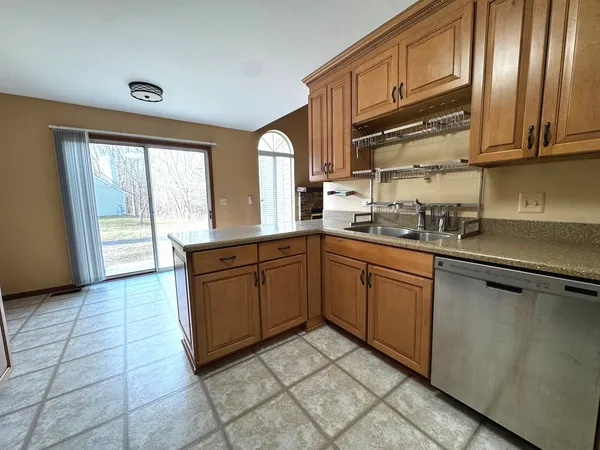 a kitchen with stainless steel appliances granite countertop a refrigerator and sink