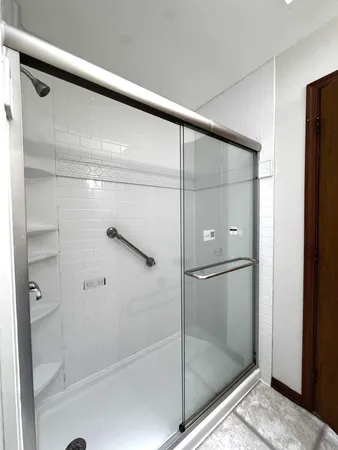 a bathroom with a white toilet and a shower