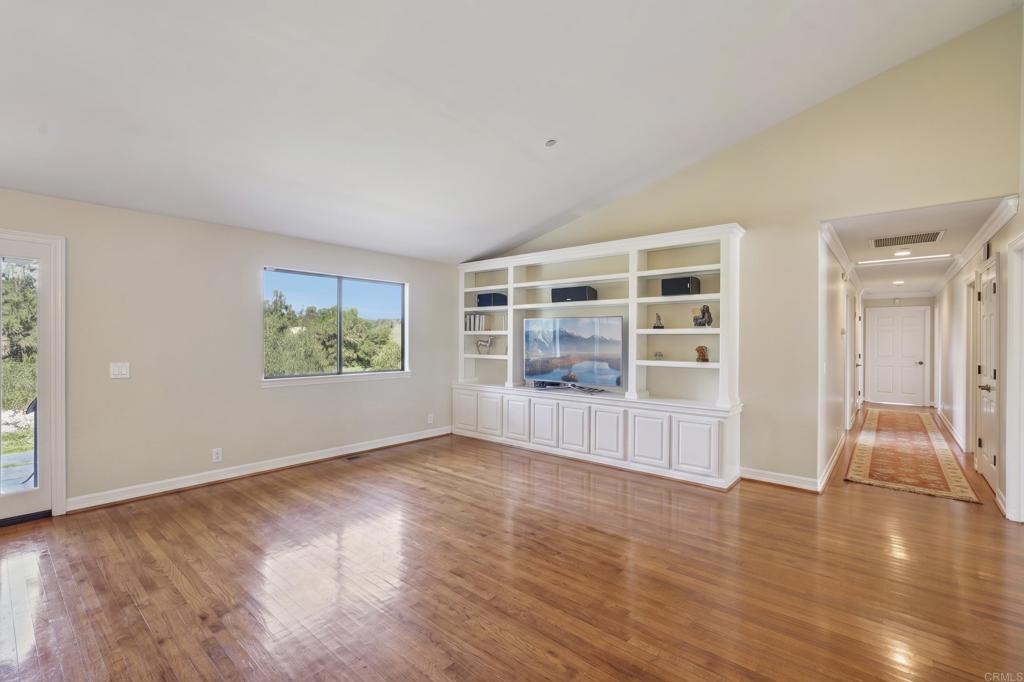 707 Live Oak Park Road South Fallbrook, CA 92028 - Photo 12 of 59 an empty room with wooden floor and windows