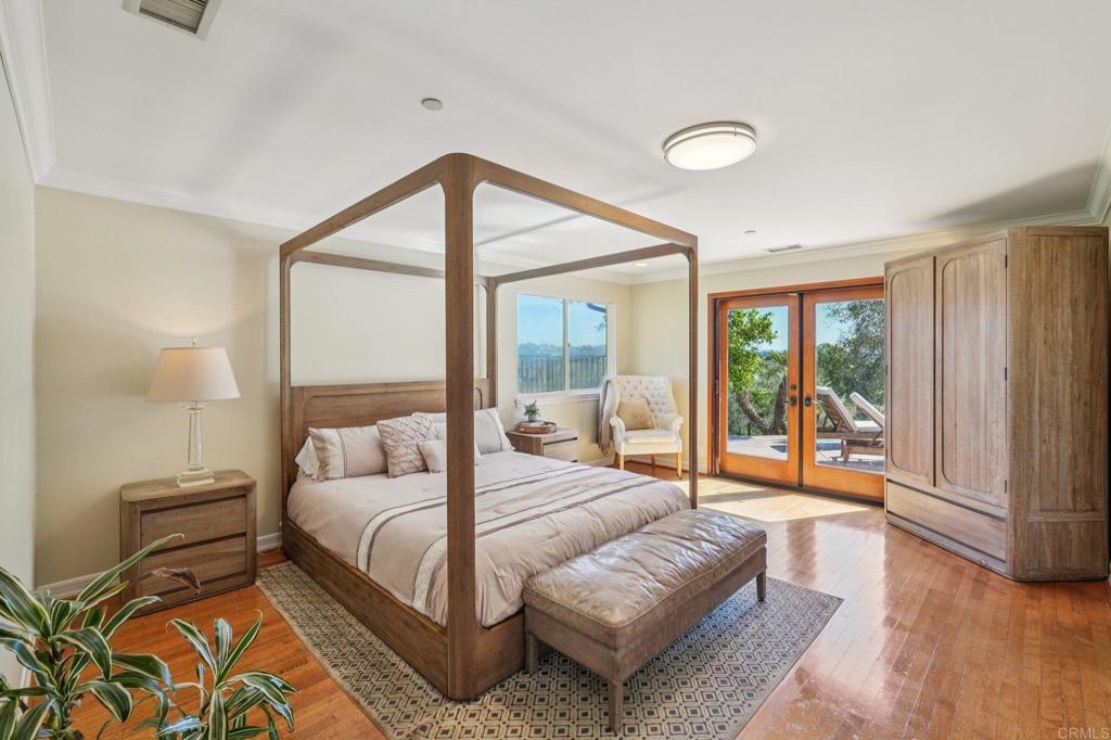 707 Live Oak Park Road South Fallbrook, CA 92028 - Photo 25 of 59 a bedroom with a bed and a large window