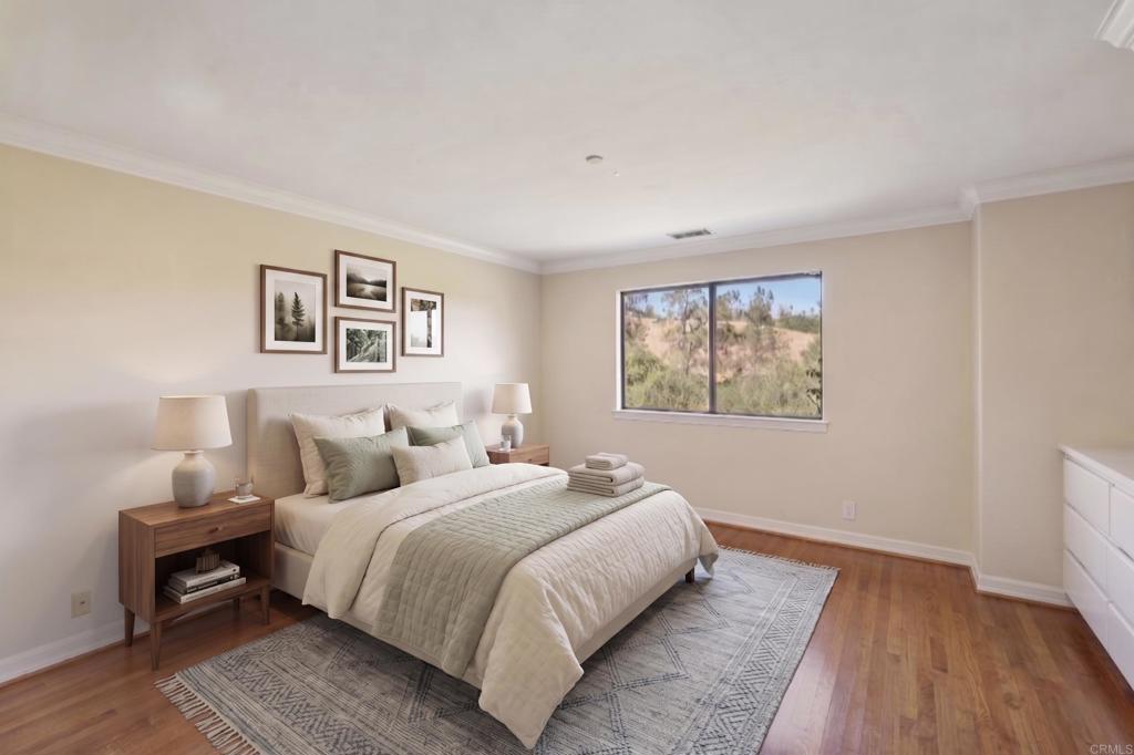 707 Live Oak Park Road South Fallbrook, CA 92028 - Photo 32 of 59 a bedroom with a bed and a painting on the wall