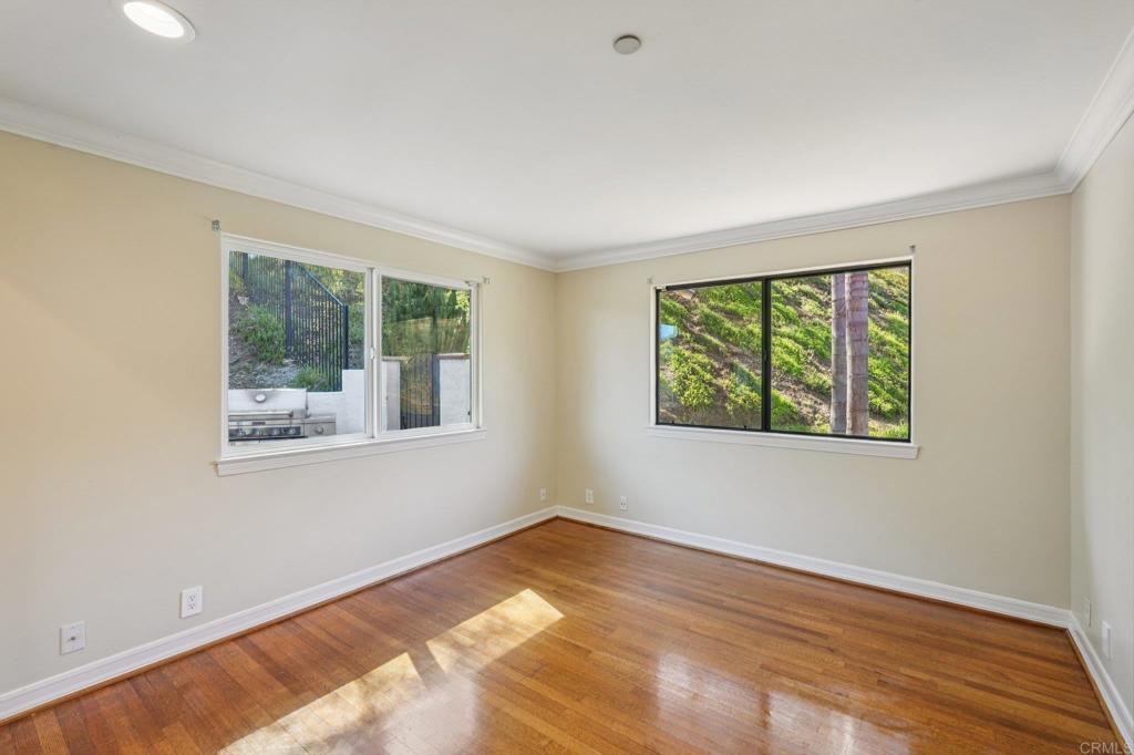 707 Live Oak Park Road South Fallbrook, CA 92028 - Photo 36 of 59 a view of an empty room with wooden floor and a window