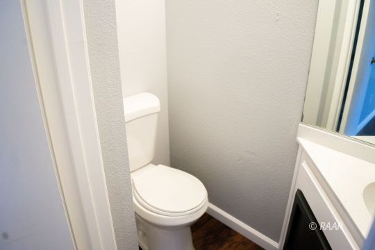 148 South Lilac Street Ridgecrest, CA 93555 - Photo 8 of 34 a white toilet sitting next to a sink