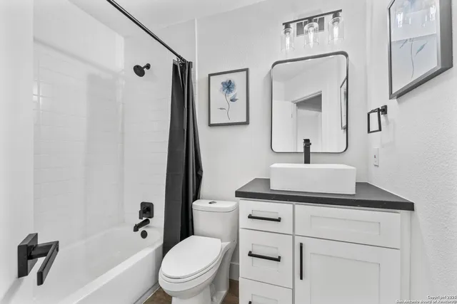 a bathroom with a sink toilet and shower